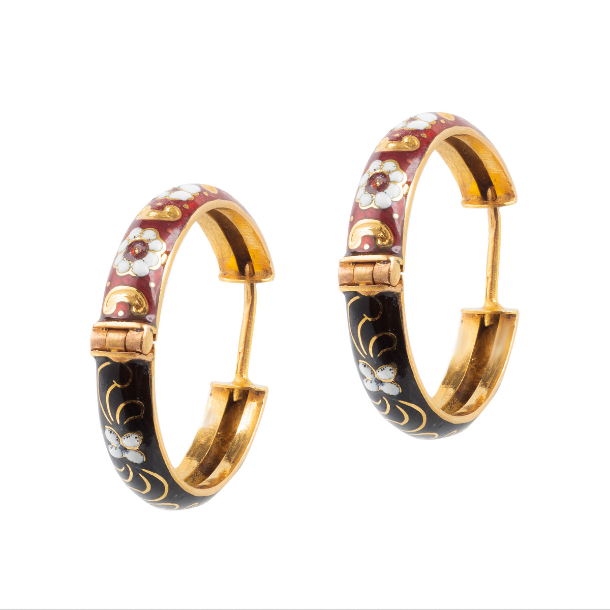 Underside view of 1950s Italian 18ct gold hoop earrings showing the black and crimson enamel, decorated with white flowers and scrollwork.