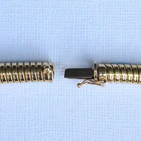 Close up of integrated clasp on 18ct gold Tubogas necklace, seamless vintage gas pipe construction, 1980s England.