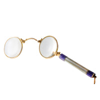 1920s English lorgnettes in gold filled metal with blue enamel and mother of pearl handle, open position showing lenses.