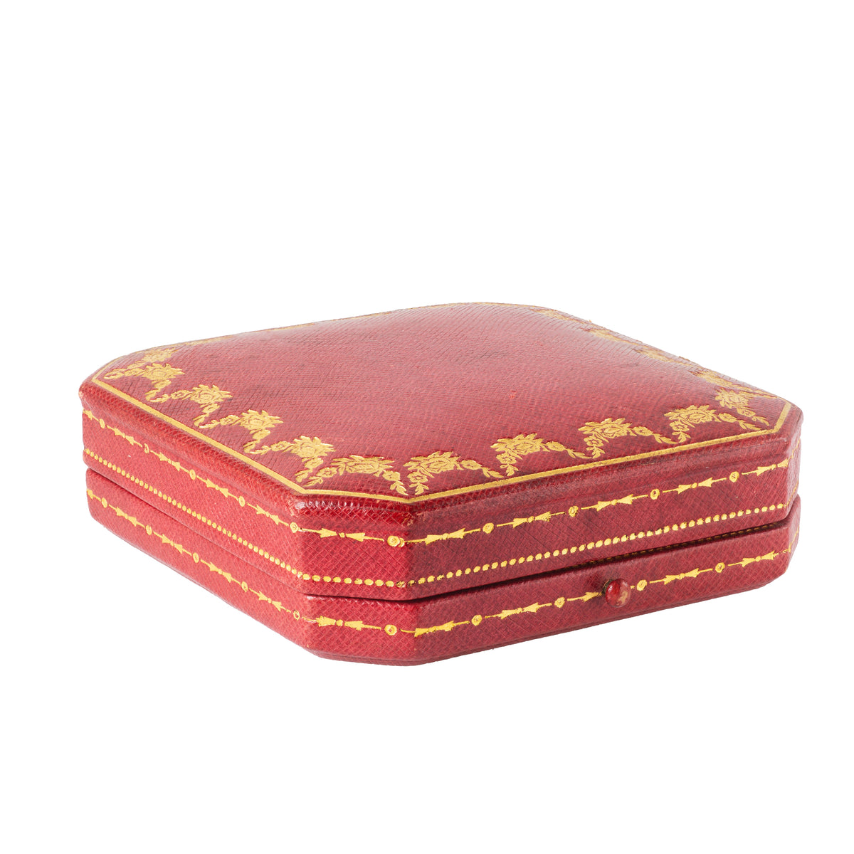 Side view of closed 1930s Cartier red leather brooch box with gold tooling and octagonal shape.