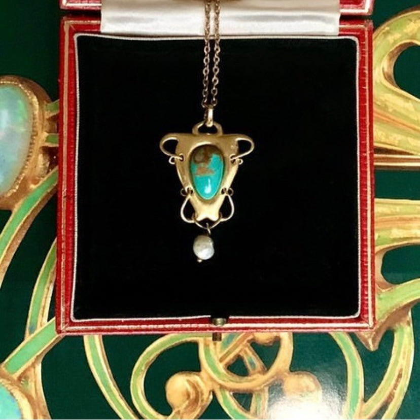 Early 1900s gold pendant designed by Archibald Knox for Liberty, showing craftsmanship and structure