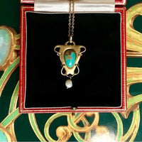 Early 1900s gold pendant designed by Archibald Knox for Liberty, showing craftsmanship and structure