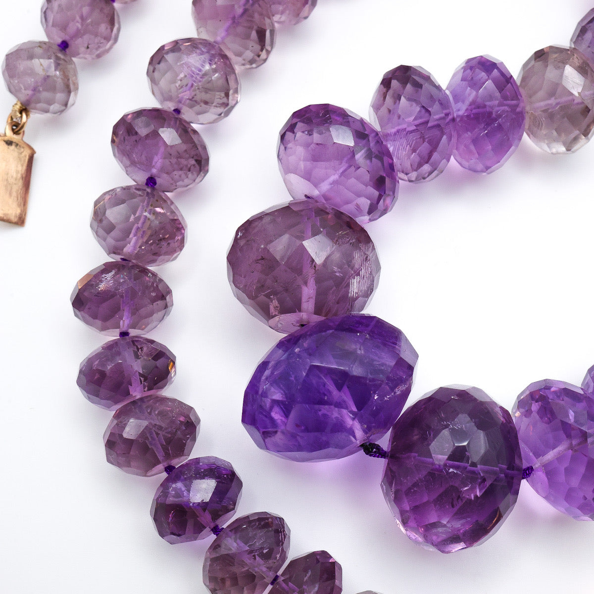 Close-up of faceted purple amethyst beads, long vintage necklace