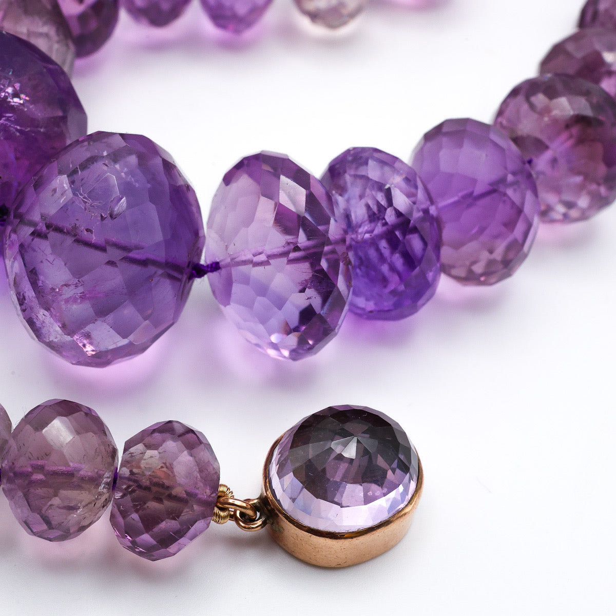 Close-up of faceted purple amethyst beads gold clasp, vintage necklace