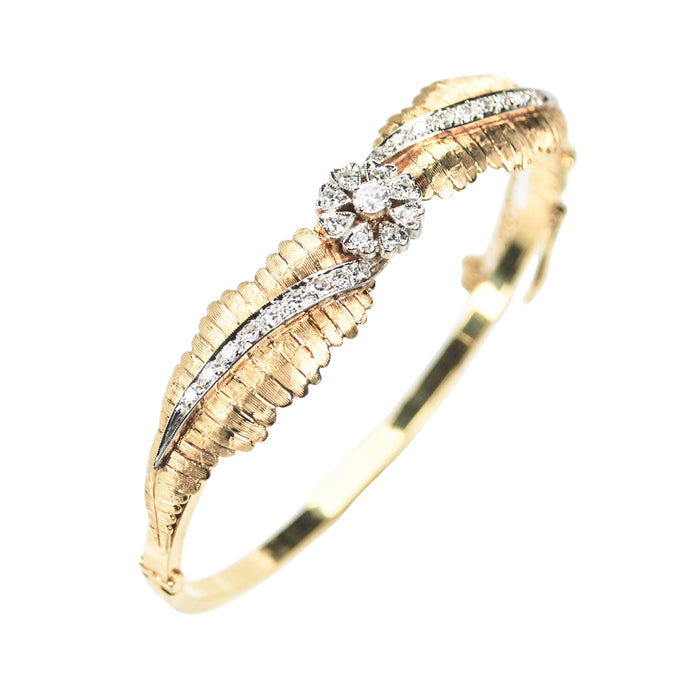 Early 20th century 14ct yellow gold hinged diamond bangle, floral design