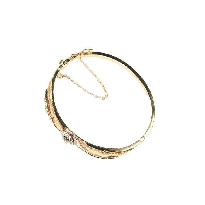 Edwardian era American hinged gold bangle with diamond floral, closed view