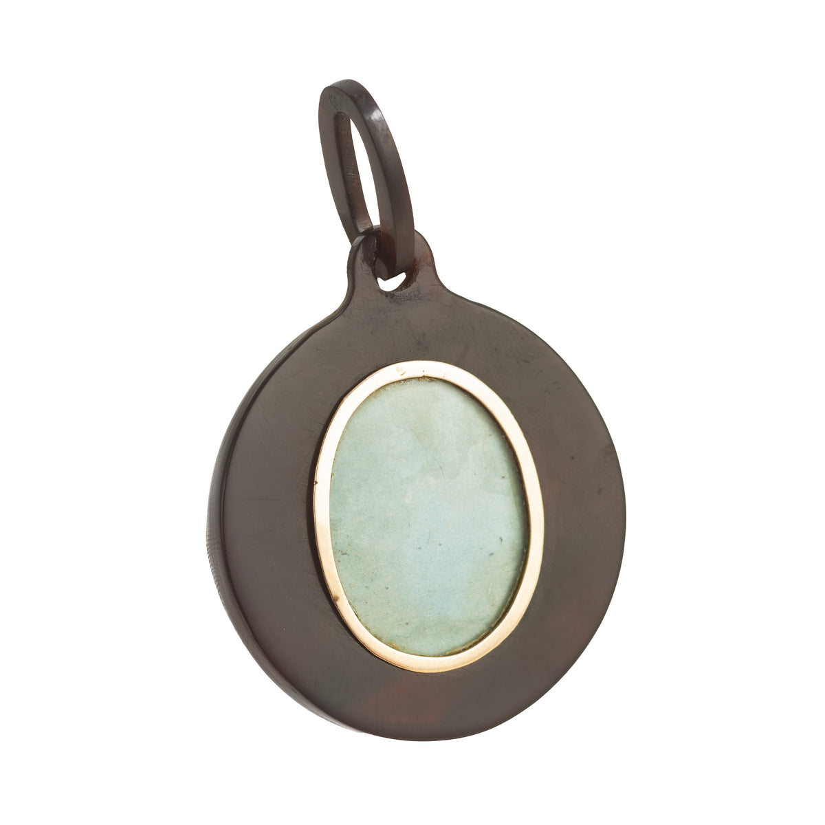 Reverse view of the Victorian piqué pendant showing the glazed locket compartment framed in gold for a keepsake or photograph, c.1880s.