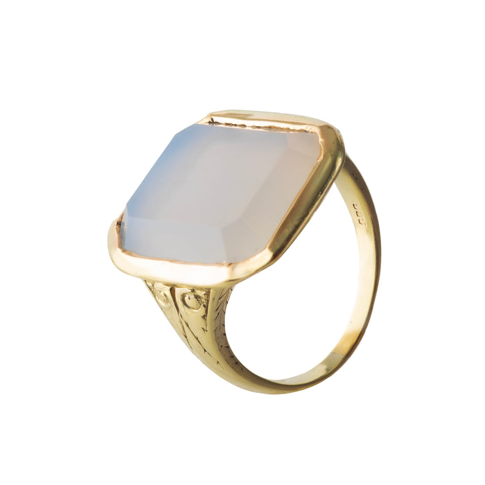 Antique c.1900 white chalcedony ring with octagonal cut stone bezel set in 14ct gold, engraved shoulders, side angle view.