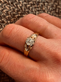 Art Deco diamond solitaire ring with cushion cut diamond in 18ct gold, shown worn on hand