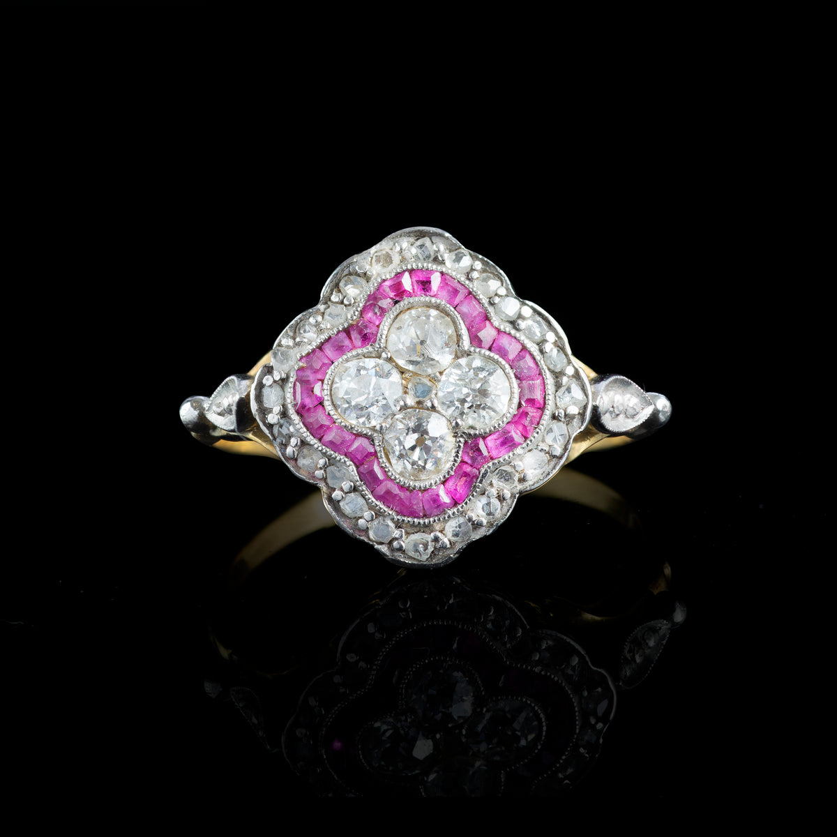Front view of 1920s Art Deco ring with ruby surround and diamond cluster, platinum and 18ct gold setting.