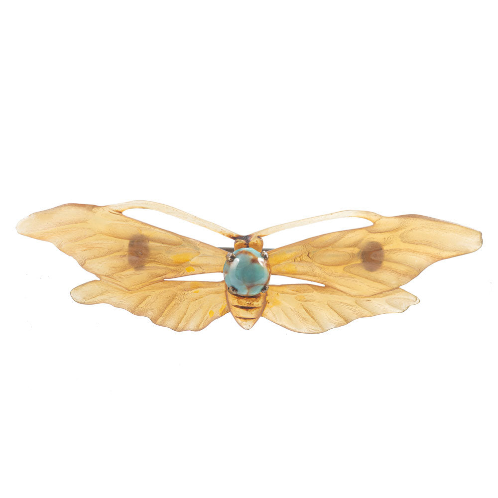 Art Nouveau French moth brooch, c.1900, with hand carved translucent horn wings and turquoise cabochon body, shown from the front.