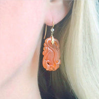 Model wearing carnelian and pearl 18ct gold drop earrings, Arts and Crafts design c.1920s