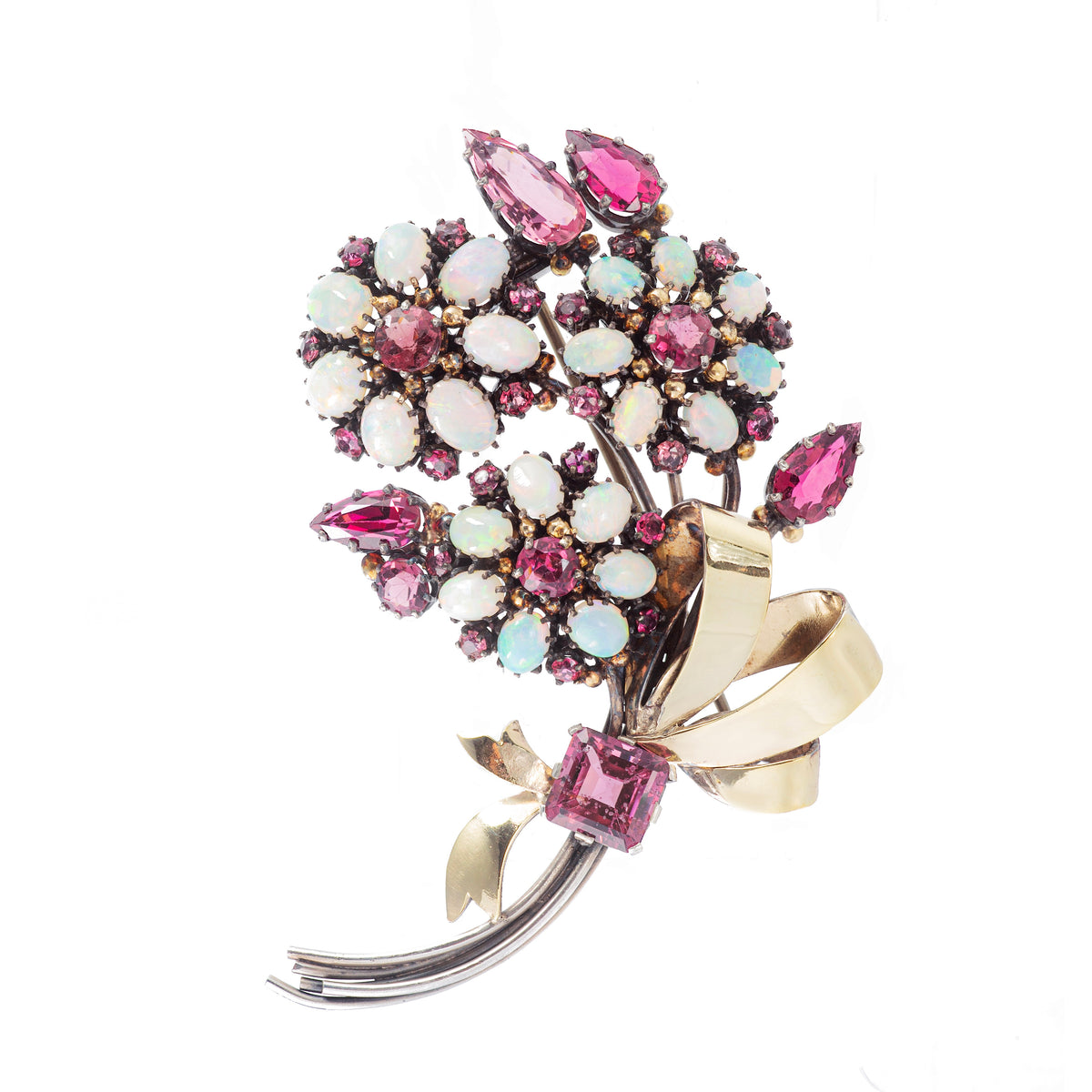 Arts & Crafts brooch by Dorrie Nossiter, 1920s design in gilt silver set with vivid garnets and glowing opals, measuring 8cm by 4.5cm.