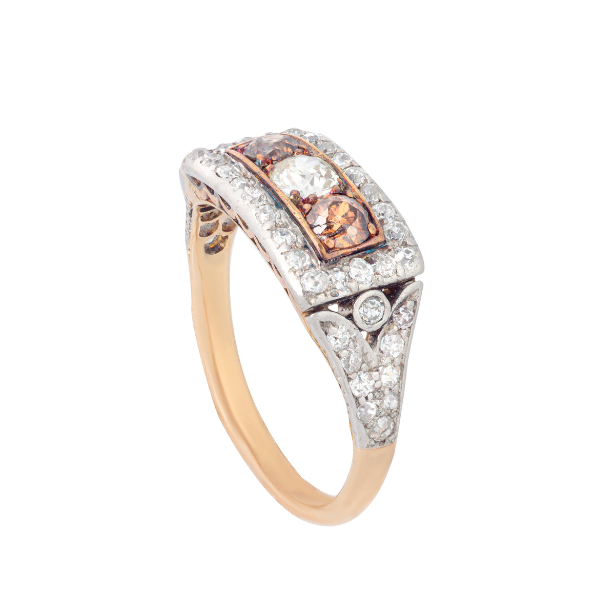 Angled side view of a 1910 Edwardian 18ct gold and platinum topped ring, set with two cognac diamonds and old cut white diamonds in a rectangular plaque design.