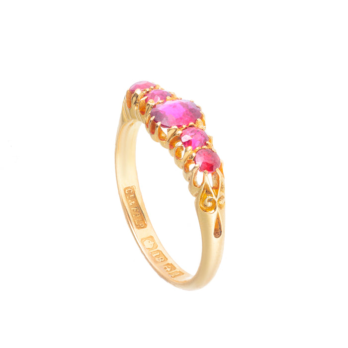 Side angle of antique Edwardian ruby ring c.1910 in 18ct gold, showing claw set five stone design and scrolled shoulders.