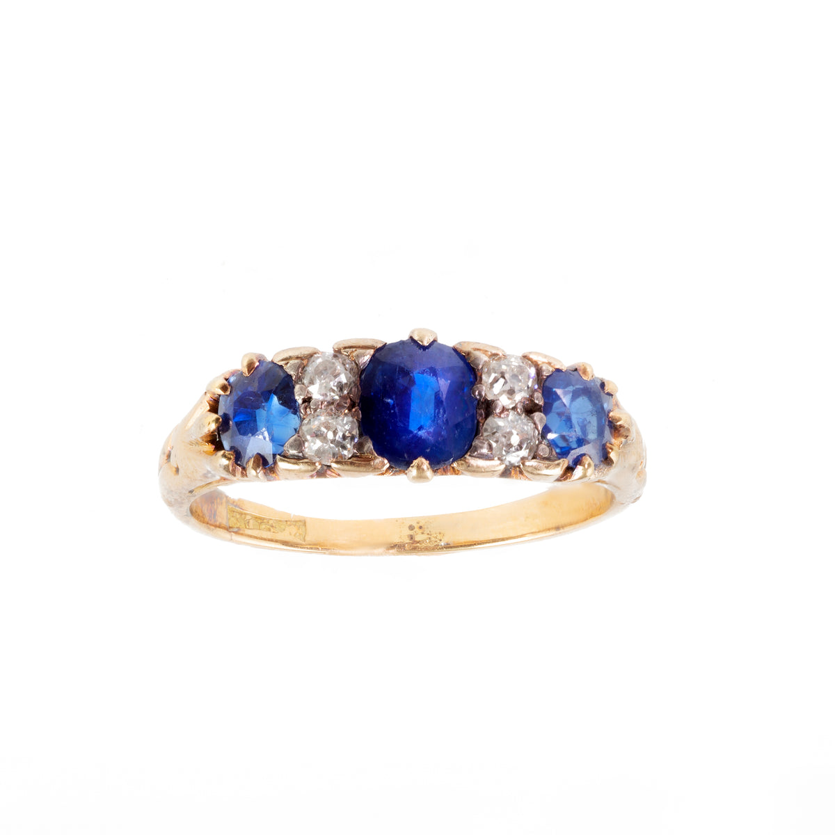 Edwardian sapphire and diamond three stone ring in 18ct gold, c.1900s, featuring rich royal blue sapphires and old cut diamonds.
