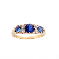 Edwardian sapphire and diamond three stone ring in 18ct gold, c.1900s, featuring rich royal blue sapphires and old cut diamonds.