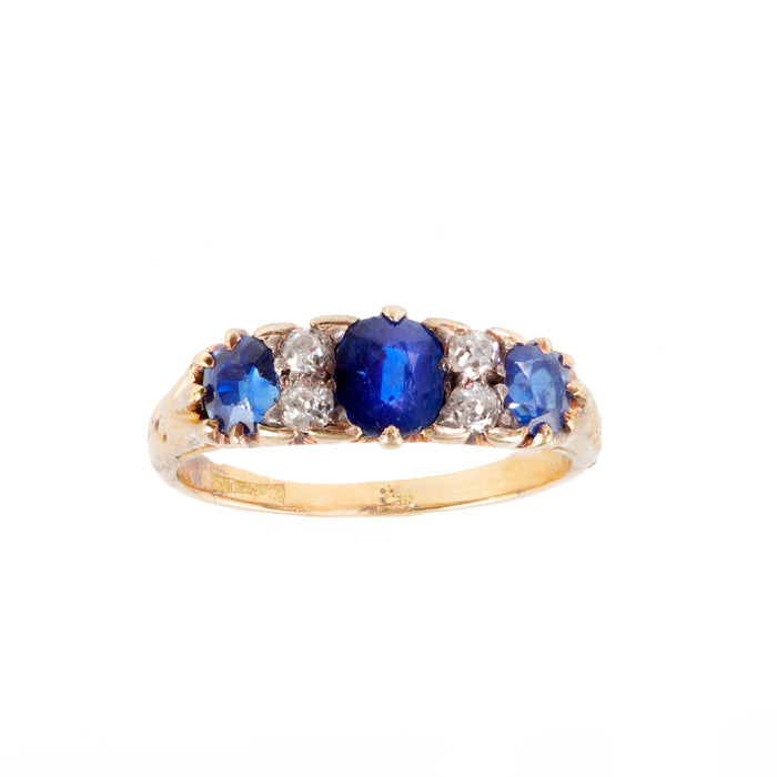 Edwardian sapphire and diamond three stone ring in 18ct gold, c.1900s, featuring rich royal blue sapphires and old cut diamonds.