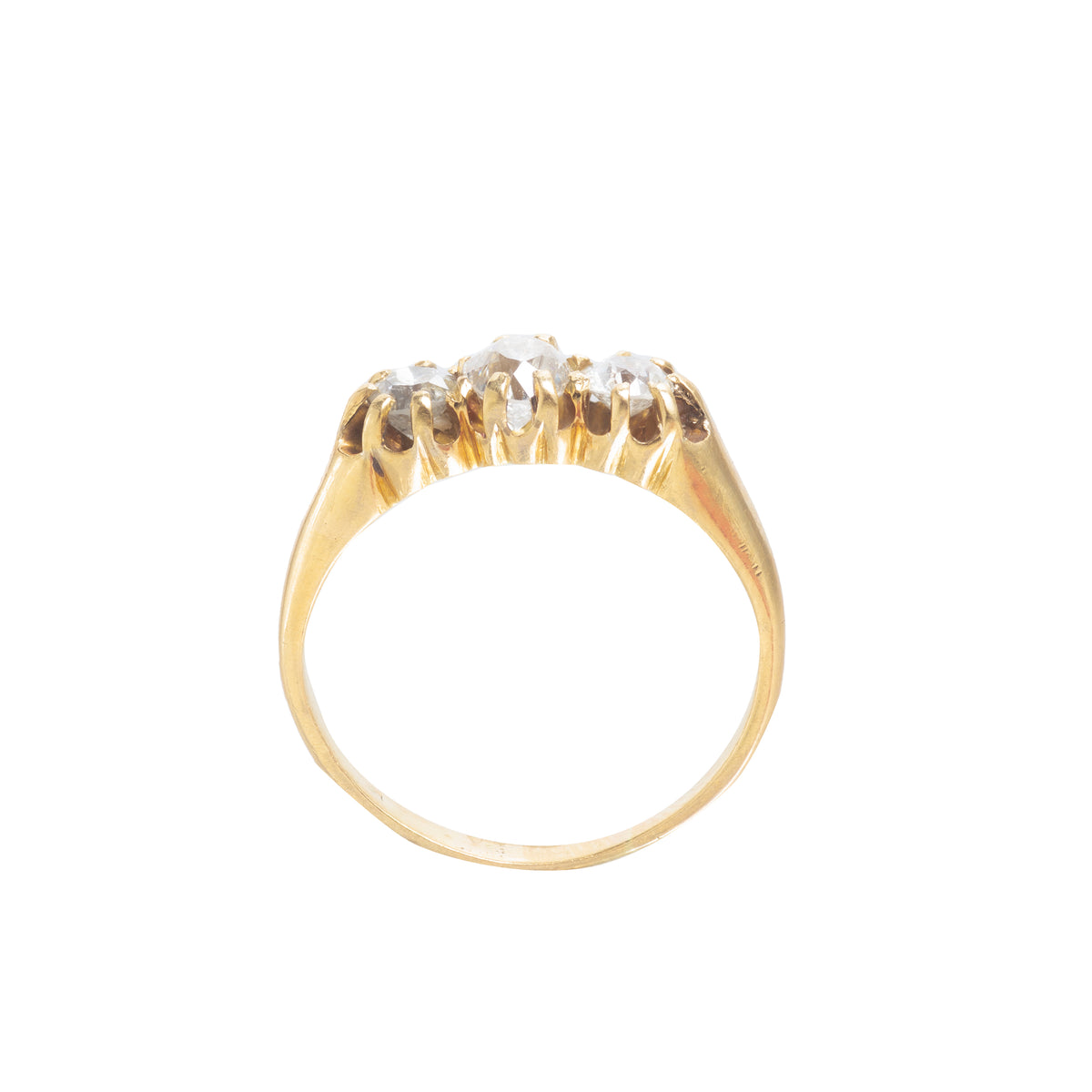 Overhead view of an Edwardian 18ct gold three stone diamond ring, showing the trio of old cut diamonds in claw settings, circa 1900s.