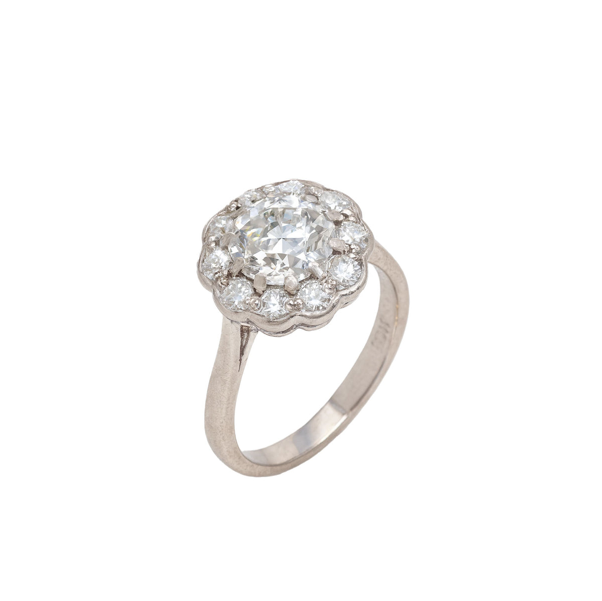Side profile of Swiss 1981 diamond cluster ring in 18ct white gold with scalloped setting and brilliant cut diamond halo.