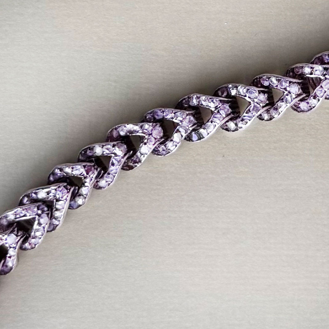 Detail of French 18ct rose gold curb bracelet, c.1880s, showing rose cut diamonds set between polished links.