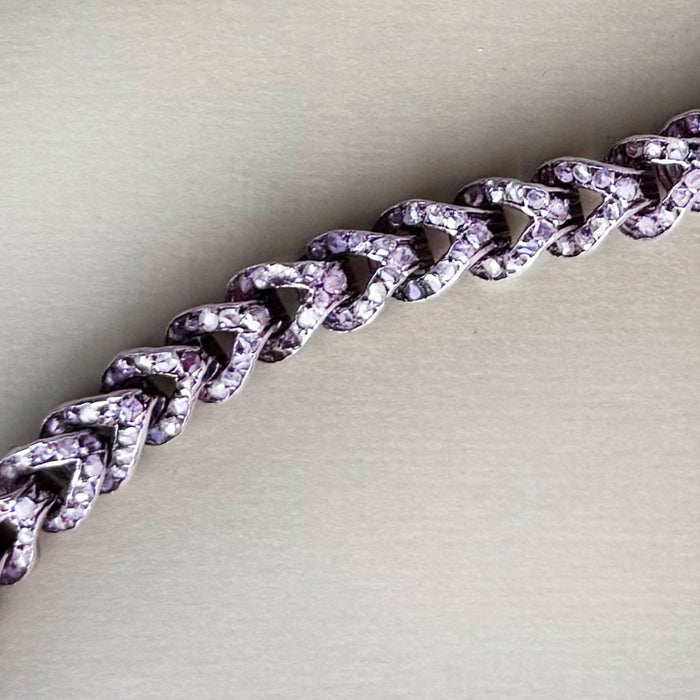 Detail of French 18ct rose gold curb bracelet, c.1880s, showing rose cut diamonds set between polished links.