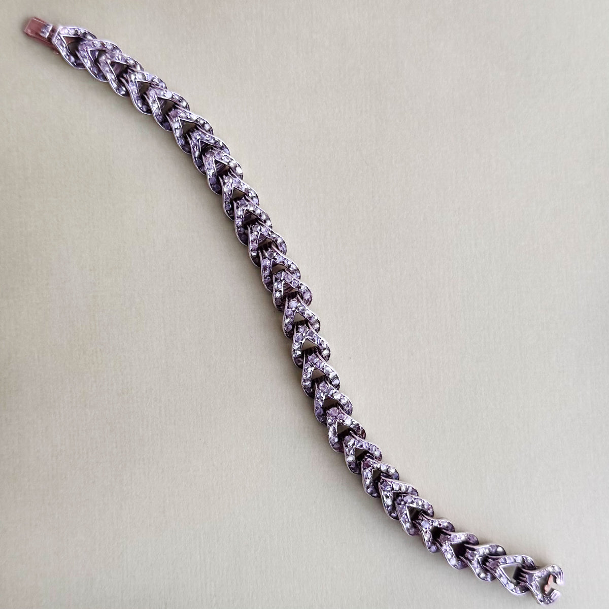 French 18ct rose gold curb bracelet, c.1880s, with rose cut diamonds, shown laid flat to display length and clasp.