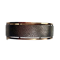 Reverse view of French Art Nouveau silver bangle showing textured silver panel framed by silver gilt borders.