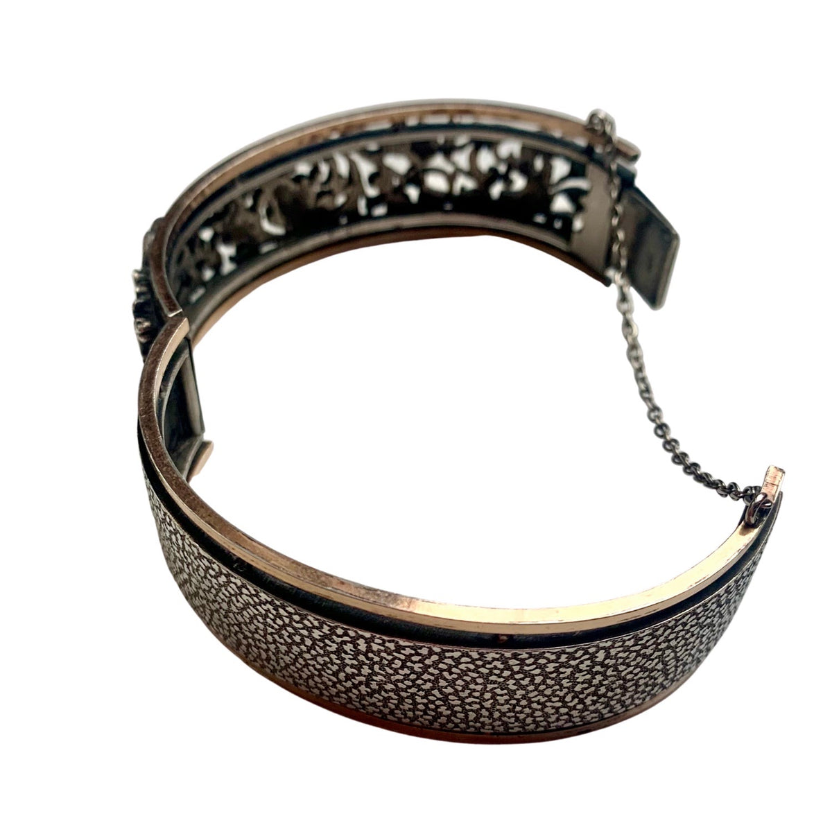 Angled view of French Art Nouveau silver foliate bangle, c.1890s, with raised floral design.