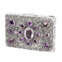 Front view of an antique French silver pill box set with amethysts, c.1880
