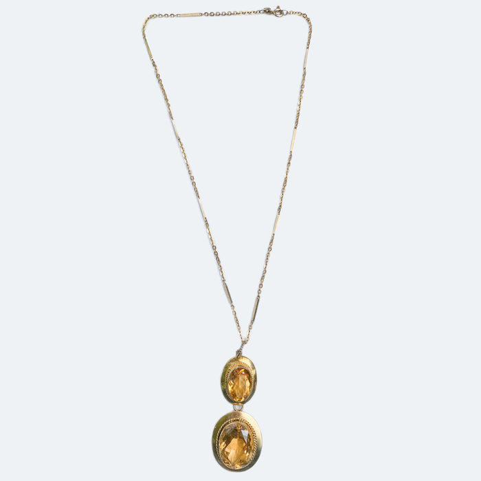 Full view of a Victorian citrine drop pendant necklace with gold bar chain, featuring two glowing citrines in hinged 15ct gold settings, c.1880.