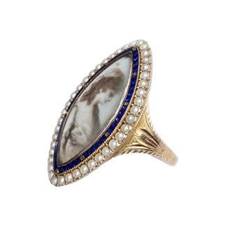 Side view of Georgian navette mourning ring with portrait miniature, cobalt blue enamel, seed pearl border and engraved 15ct gold shoulders.