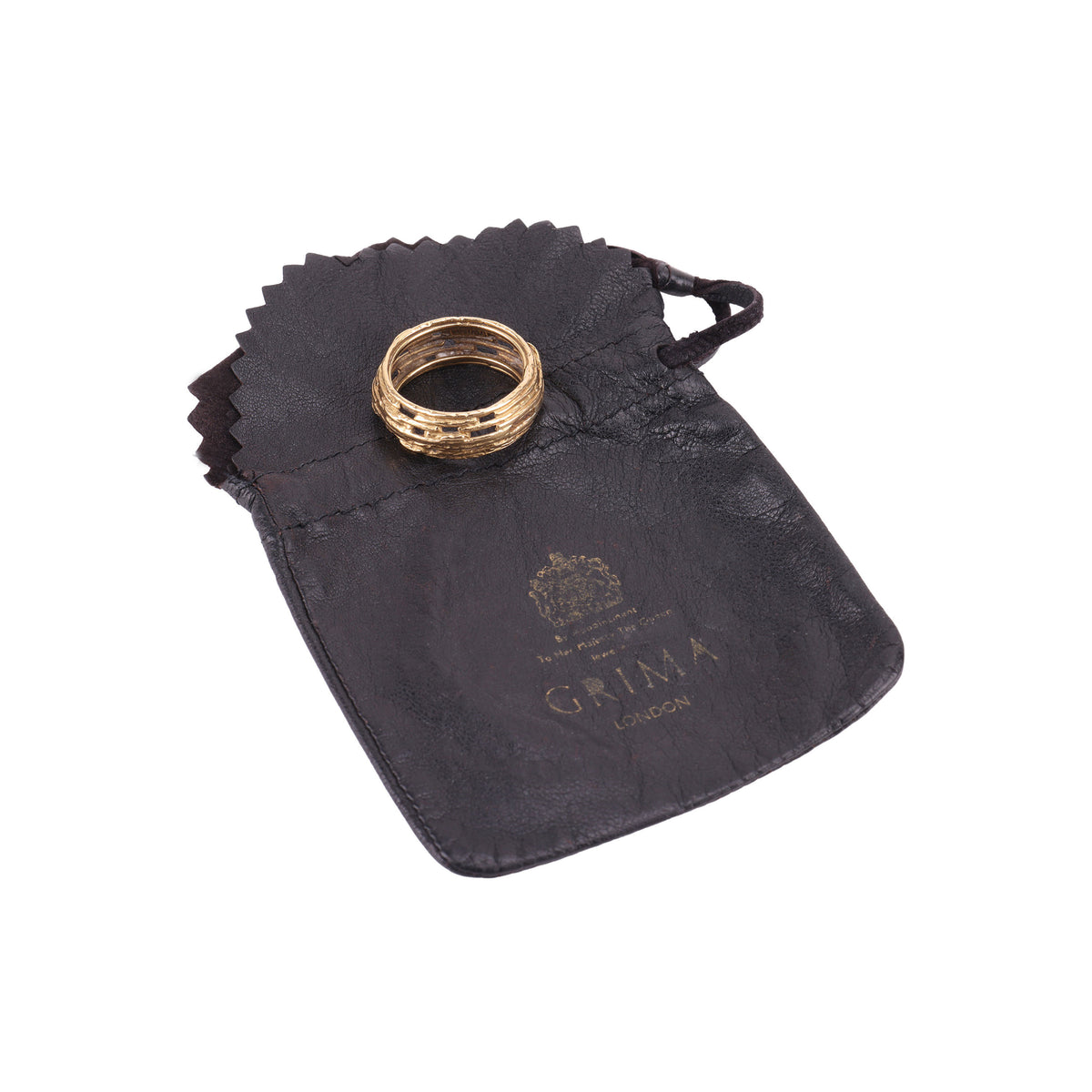Vintage 18ct gold Grima ring displayed on its original 1970s brown leather Grima pouch, showing authentic period packaging.