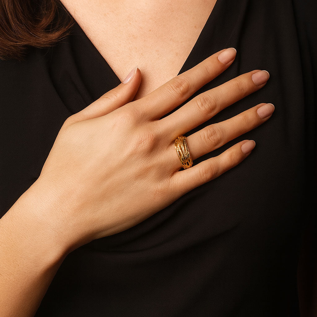 Vintage 18ct gold openwork ring by Andrew Grima shown worn on the hand, illustrating its bold sculptural form and elegant fit.