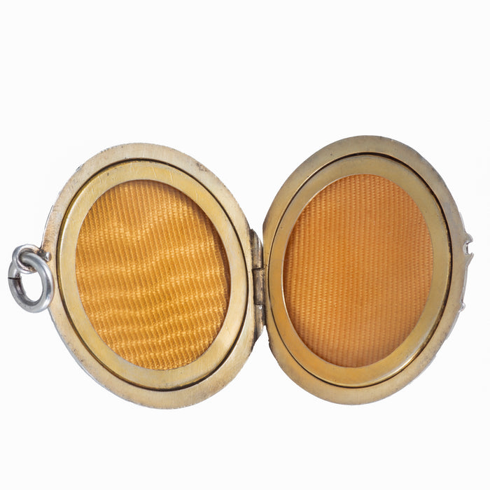 Edwardian lavender guilloché enamel and silver gilt locket shown open, revealing the warm gilt interior and original photo frames, English c.1900s.