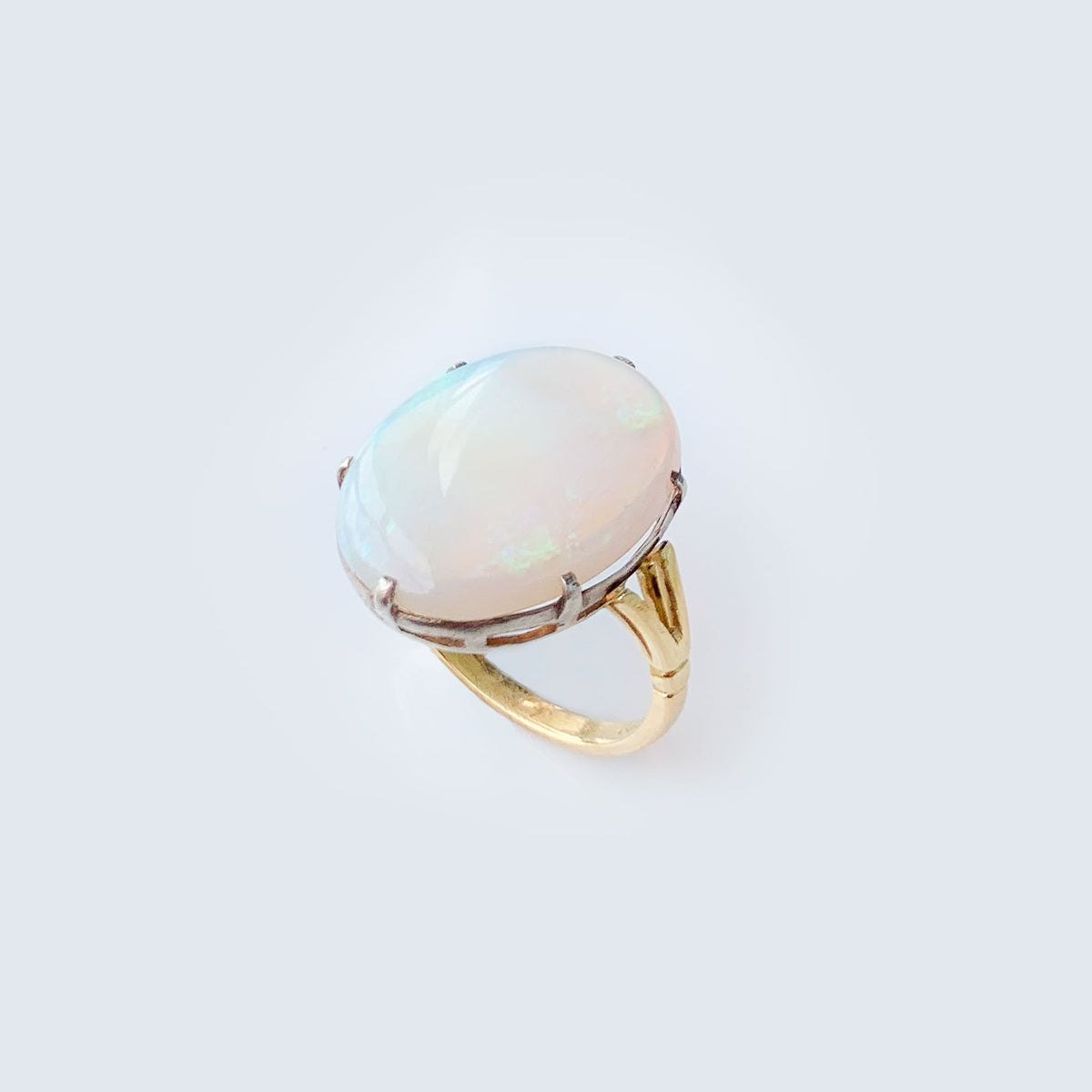 Side view of antique 18ct gold opal ring from 1930s with soft play of colour
