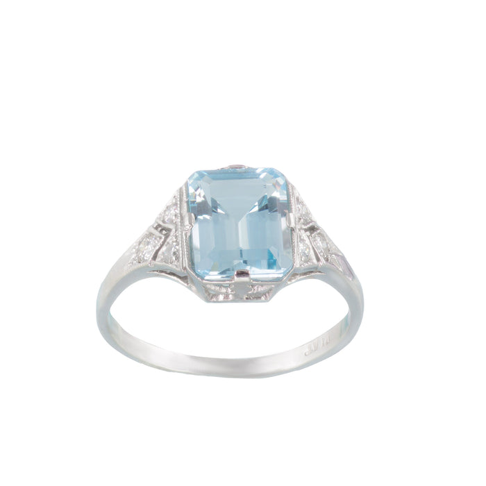 Front view of vintage 1950s platinum ring with 2.5ct emerald cut aquamarine and diamond shoulders in a millegrain setting, UK size N½.