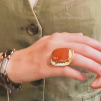Model wearing oversized 1950s Swedish carnelian ring on finger