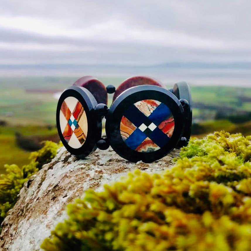 Scottish agate and onyx pietra dura bracelet, c.1880, photographed on a mountain background