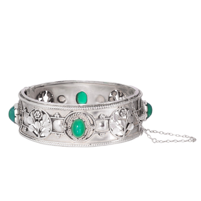 Front view of an Arts & Crafts silver cuff bangle set with vivid green chalcedony cabochons, England c.1930s