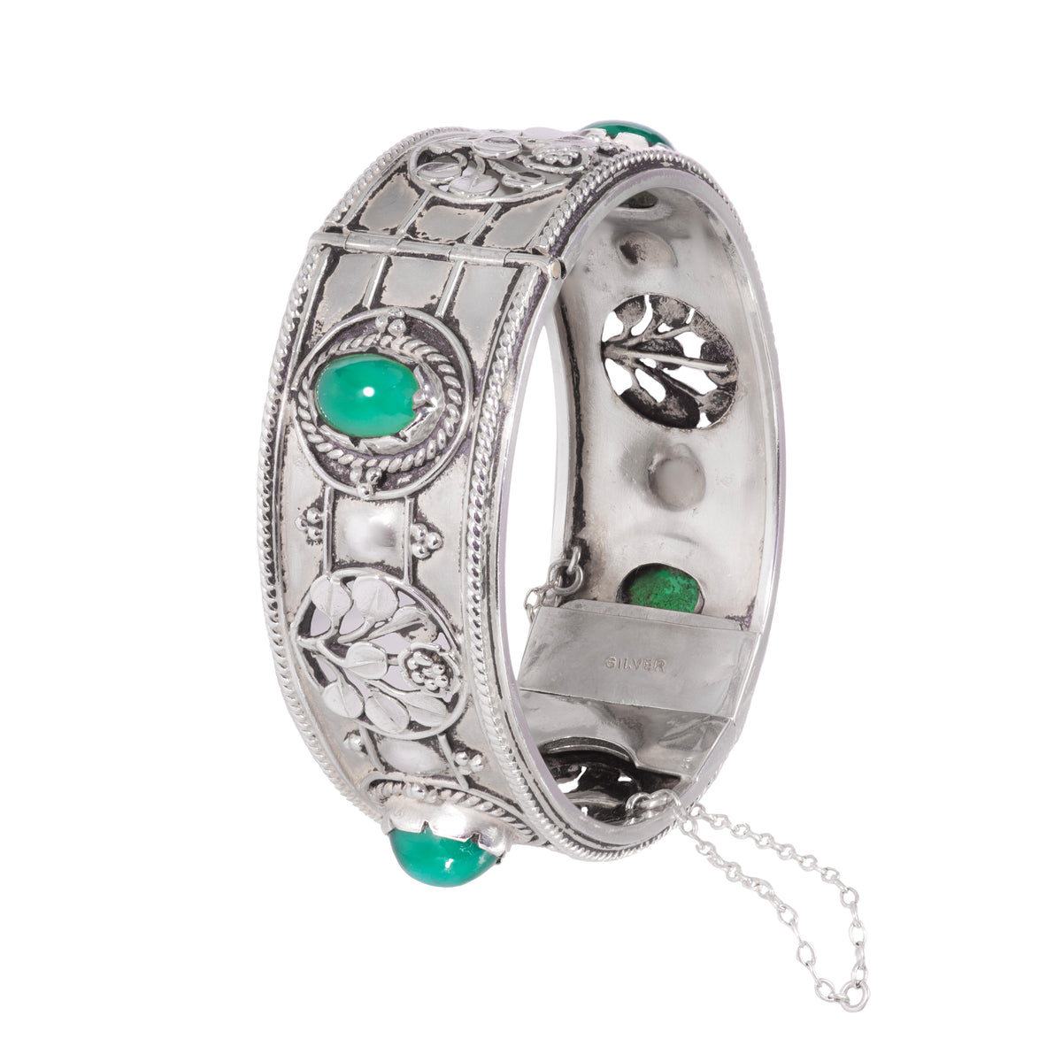 Side angle of 1930s Arts & Crafts silver and green chalcedony cuff bracelet showing floral repoussé details and safety chain.