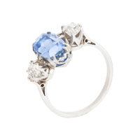 Detailed side angle of sapphire and diamond Art Deco ring highlighting platinum craftsmanship and claw setting.