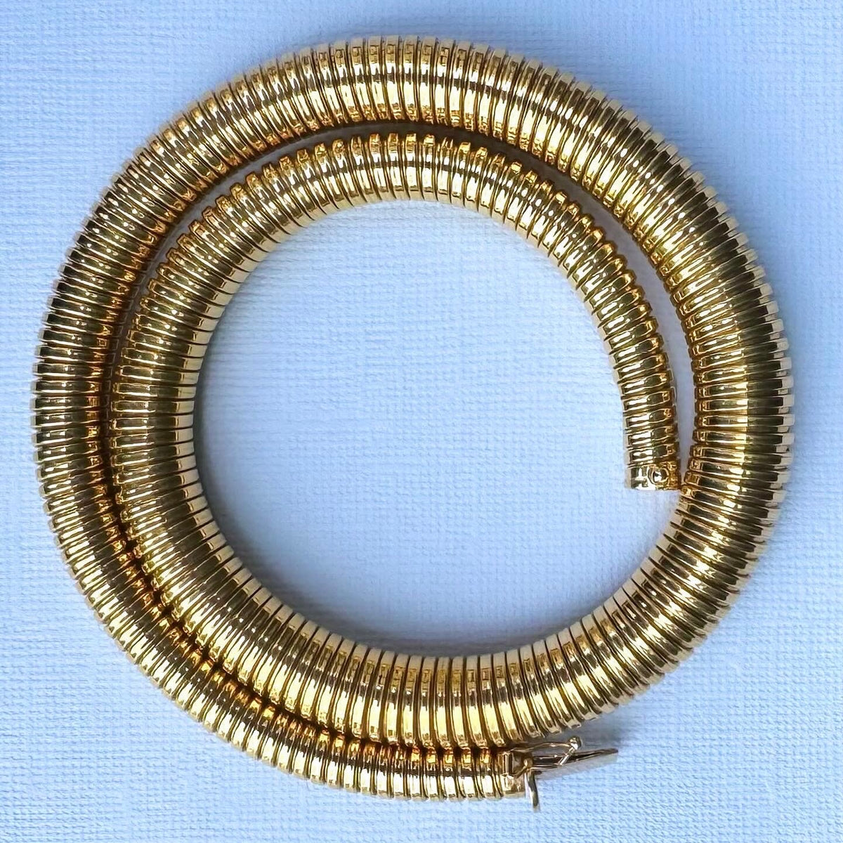 Detailed view of Tubogas coiled links in solid 18ct gold, vintage 1980s necklace with flexible collar design.