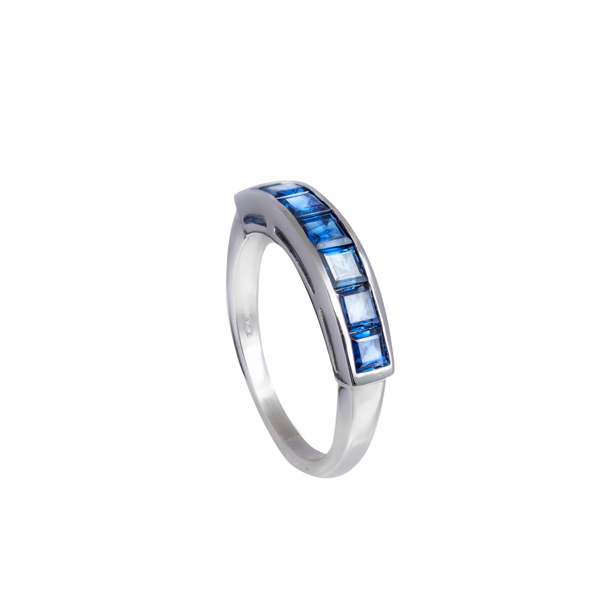 1970s half hoop sapphire ring in 18ct white gold with square-cut channel-set sapphires, shown on white background and worn on hand.