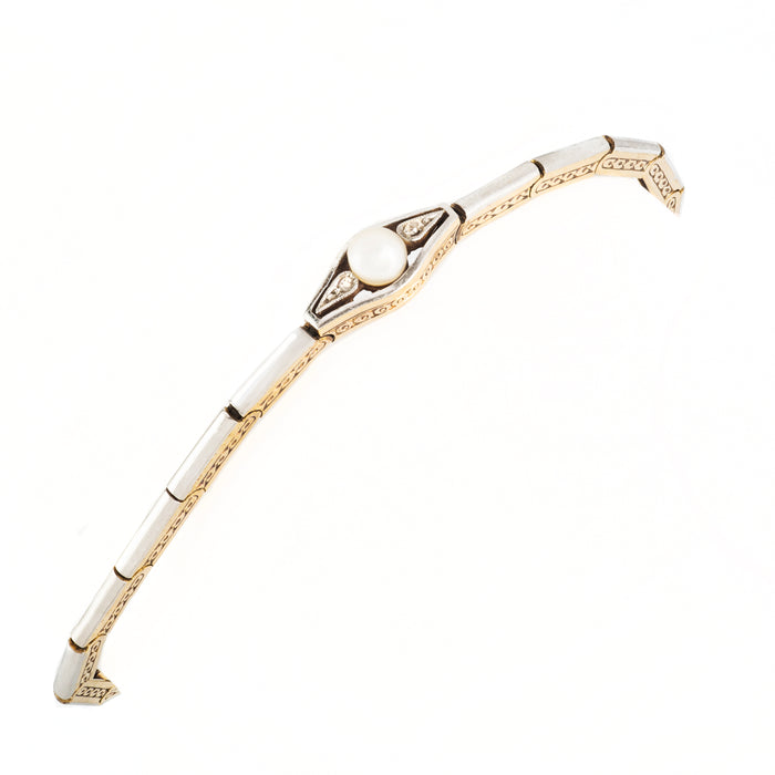 Belle Époque-era bracelet featuring engraved gold links and platinum panels, set with pearl and old-cut diamonds.