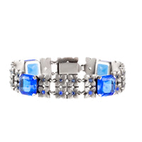 Silver floral bracelet with square and round blue paste stones, c.1930s–40s, geometric and botanical design, 18cm long.