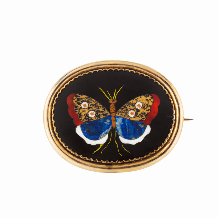 Florentine pietra dura brooch with inlaid butterfly in jasper, chalcedony, and lapis, set in black slate and framed in 9ct gold.