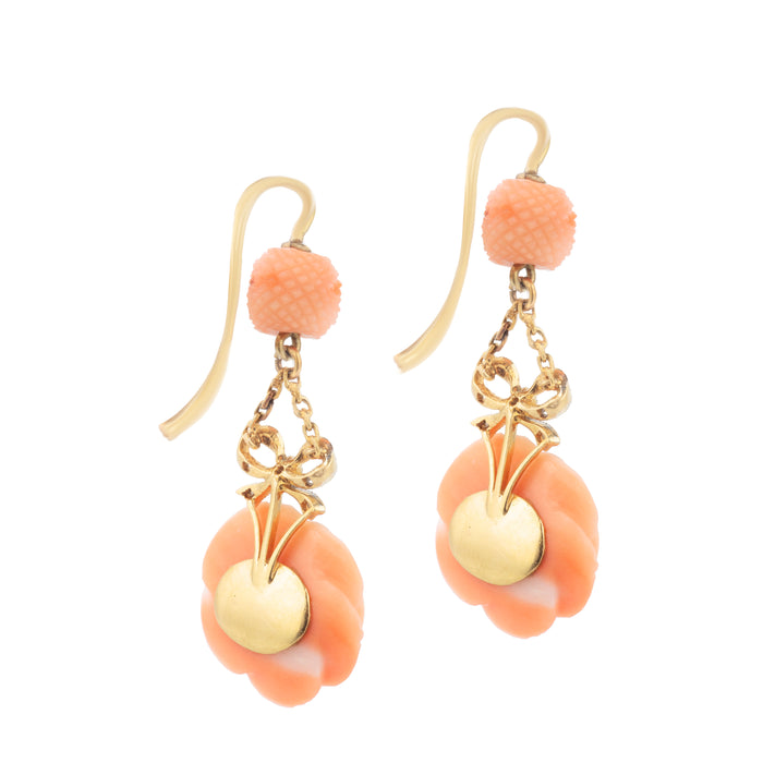 Close-up of back of antique carved coral roses with diamond-set bows in gold, c.1910