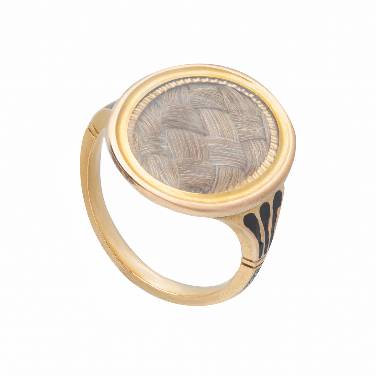 Close-up of antique gold mourning ring showing enamel shoulders and inscribed name “F.M. Tatton 1777” on shank.