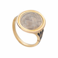 Close-up of antique gold mourning ring showing enamel shoulders and inscribed name “F.M. Tatton 1777” on shank.